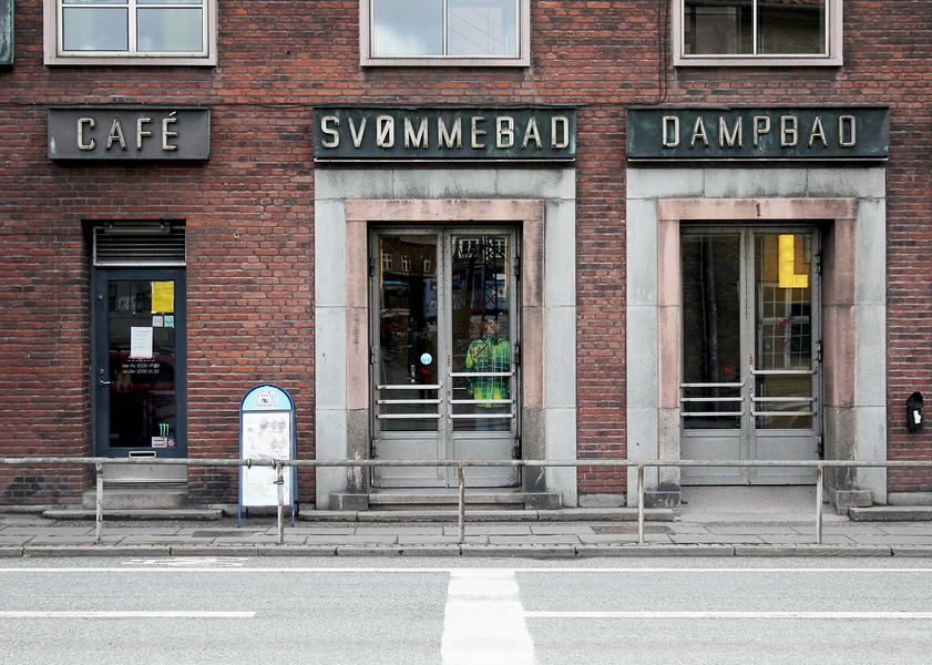 Badeanstalten Spanien Vestvendt facade med originale lamper og typografi, tidstypisk for 1930'ernes funkisstil